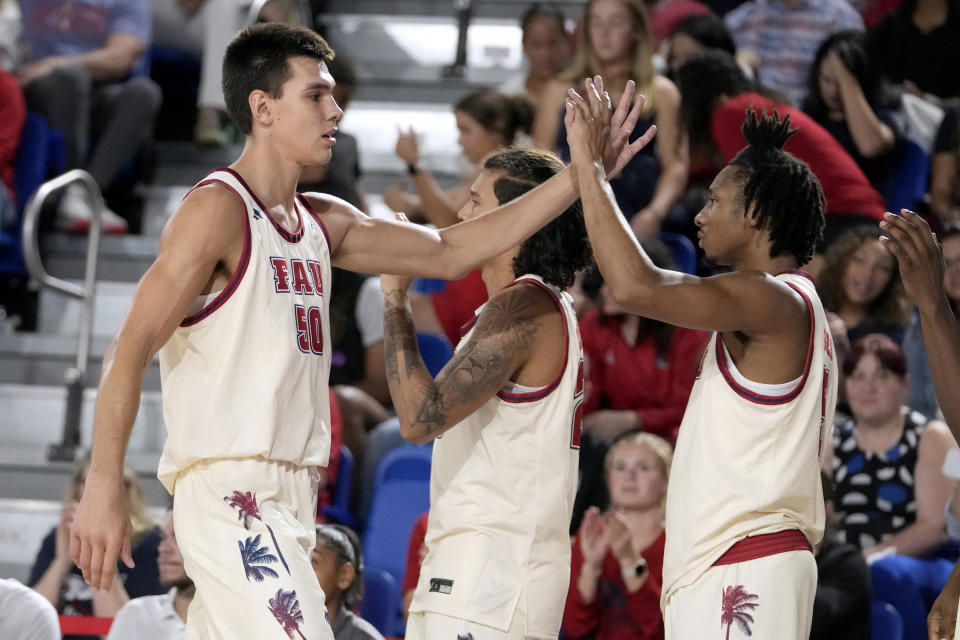 Florida Atlantic center Vladislav Goldin (50) is high-fived as he comes out of the game during the second half of an NCAA college basketball game against Liberty, Thursday, Nov. 30, 2023, in Boca Raton, Fla. (AP Photo/Lynne Sladky)