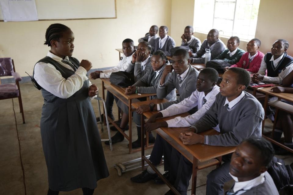 Bridget Chanda, left, interprets climate change terms to students, who are deaf, during a lesson at the Chileshe Chepela Special School in Kasama, Zambia, Wednesday, March 6, 2024. Chanda is intent on helping educate Zambia's deaf community about climate change. As the southern African nation has suffered from more frequent extreme weather, including its current severe drought, it's prompted the Zambian government to include more climate change education in its school curriculum. (AP Photo/Tsvangirayi Mukwazhi)
