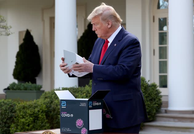 US President Donald Trump holds a new COVID-19 test kit developed by Abbott Labs during the daily coronavirus briefing at the Rose Garden of the White House on March 30, 2020 in Washington, DC. 