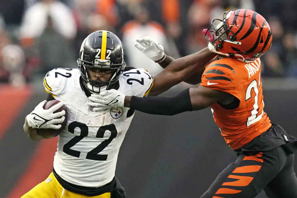 Pittsburgh Steelers running back Najee Harris (22) stiff arms Cincinnati Bengals cornerback Mike Hilton (21) during the second half of an NFL football game in Cincinnati, Sunday, Nov. 26, 2023. The Steelers won 16-10. (AP Photo/Carolyn Kaster)