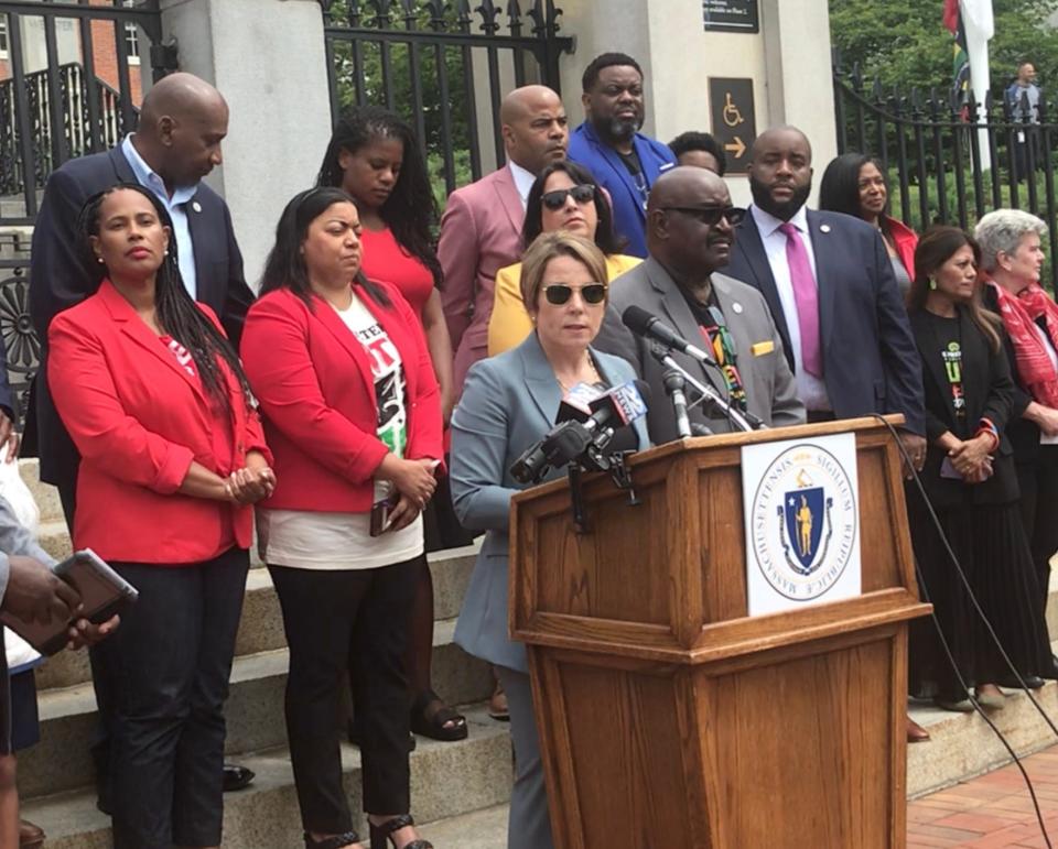 Gov. Maura Healey, surrounded by members of the Black and Latino Legislative Caucus and others, speaks during the Juneteenth 2023 ceremony in front of the Statehouse.