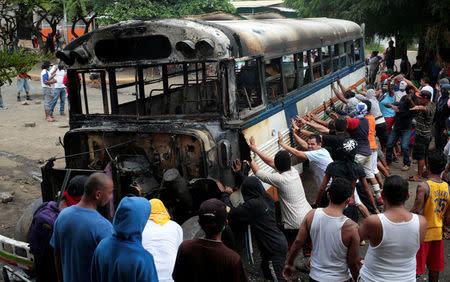 Demonstrations place a burned bus as a barricade during a protest against Nicaragua's President Daniel Ortega's government in Tipitapa, Nicaragua June 14, 2018. REUTERS/Oswaldo Rivas