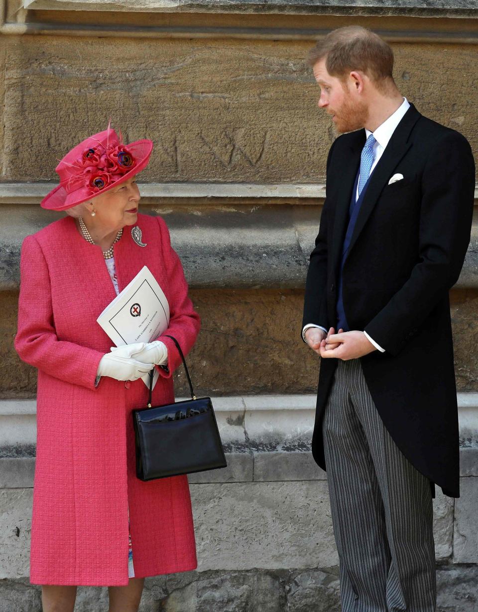 Britain's Queen Elizabeth II (L) and Britain's Prince Harry, Duke of Sussex, leave St George's Chapel in Windsor Castle, Windsor, west of London, on May 18, 2019, after the wedding of Lady Gabriella Windsor and Thomas Kingston - AFP 