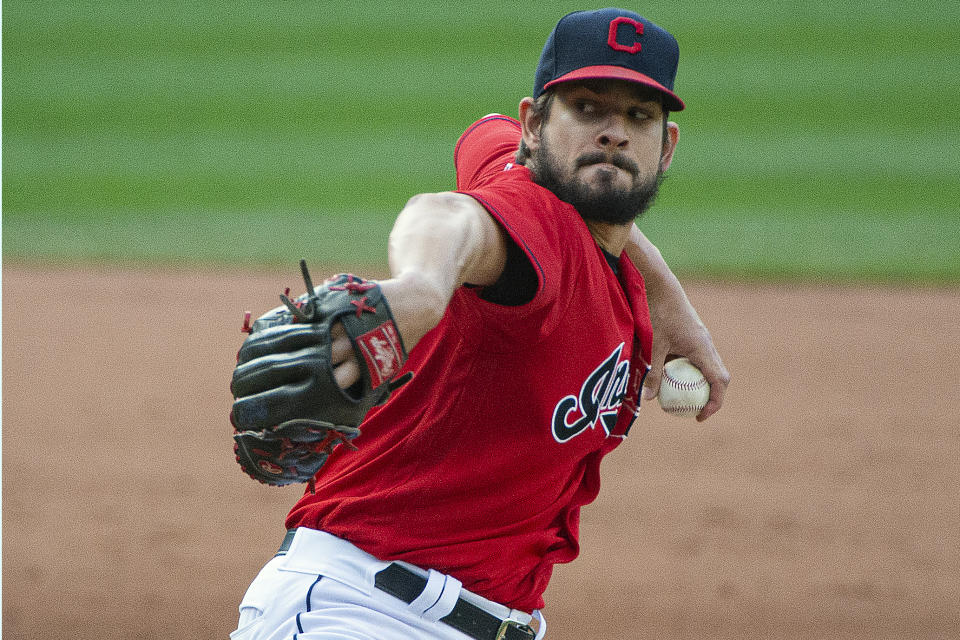 FILE - In this Sept. 27, 2020, file photo, Cleveland Indians relief pitcher Brad Hand delivers to Pittsburgh Pirates' Josh Bell during the ninth inning of a baseball game in Cleveland. The Cleveland Indians have declined contract options on Brad Hand and first baseman Carlos Santana for next season, decisions that will initially cut $27 million from the team's payroll. (AP Photo/Phil Long, File)