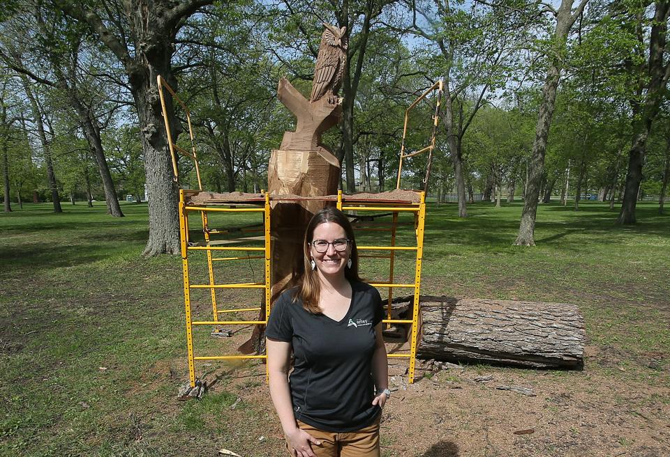 Gabriele Edwards, the Ames city forester, stands near a black walnut tree in Brookside Park on Thursday, May 11, 2023. The tree needed to be taken down, but Edwards championed retaining the trunk for the carving.