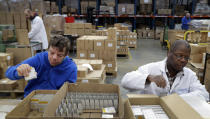 FILE - In this Thursday, Jan. 17, 2019 file photo, David Wright, left, and Dan During, right, pack bars of soap at the Clarity-The Soap Co. premises in London. The U.K. election result means Britain's departure from the European Union will almost certainly happen - after multiple delays - on Jan. 31, as scheduled. But for companies that have had to plan for all sorts of potentially chaotic outcomes to Brexit, even just a little clarity is a breath of fresh air. “The idea that the situation with Brexit is going to be resolved is good for business,” said Andy Zneimer, who handles communications for a small soap business in east London called Clarity-The Soap Co. (AP Photo/Kirsty Wigglesworth)