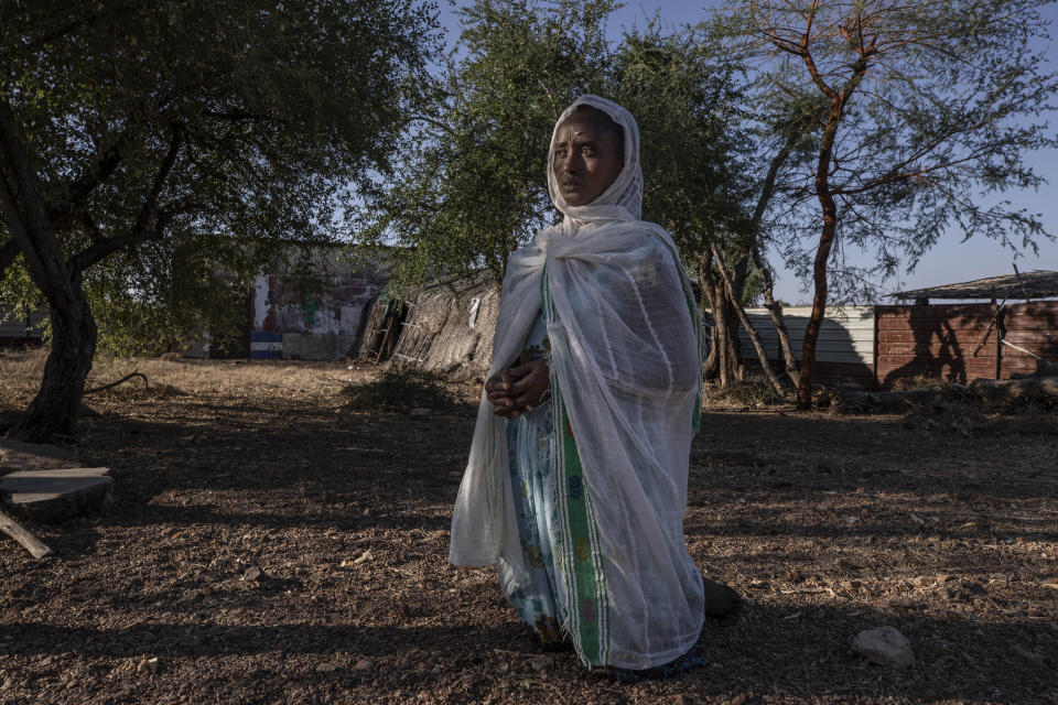 A Tigrayan woman who fled the conflict in Ethiopia's Tigray region, prays after Sunday Mass ends at a church, near Umm Rakouba refugee camp in Qadarif, eastern Sudan, Nov. 29, 2020. (AP Photo/Nariman El-Mofty)