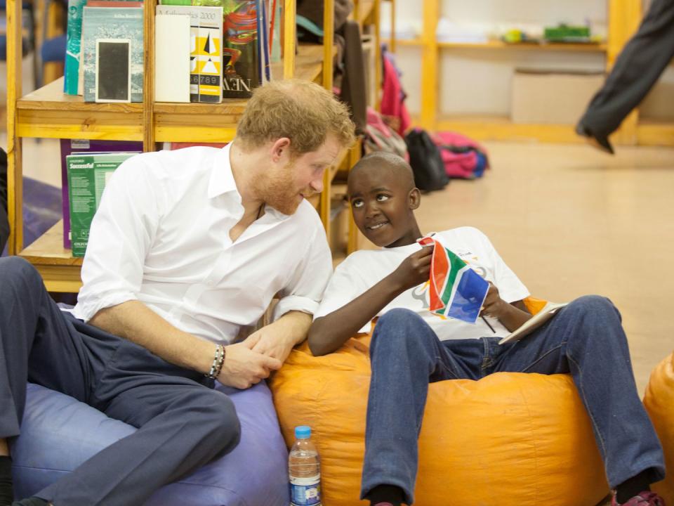 <p>Prince Harry meets Prince Mtimkulul as he meets children participating in the Nelson Mandela Champion within program in Soweto.</p>
