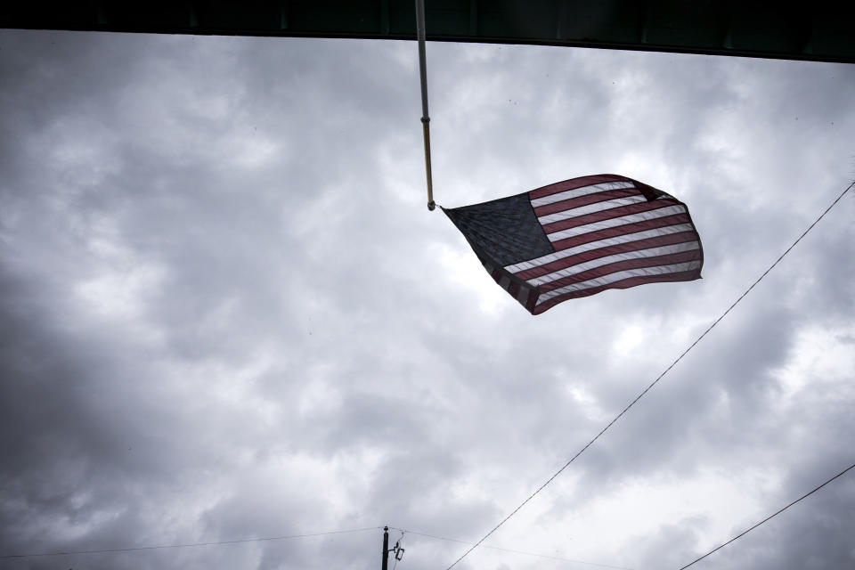 An American flag flaps in the wind after part of it broke loose from its pole on a house as the rain bans from Hurricane Dorian still linger over Tybee Island, Ga. on Sept. 5, 2019. (Photo: Stephen B. Morton/AP)