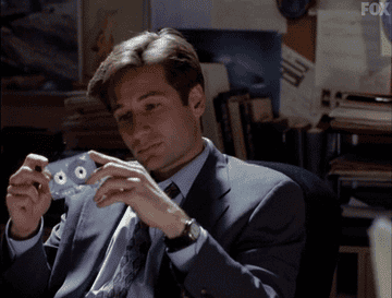 Mulder holding an X-Files cassette tape