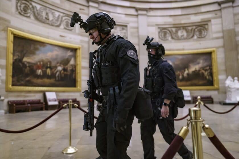 FILE - Members of the U.S. Secret Service Counter Assault Team walk through the Rotunda as they and other federal police forces responded as violent protesters loyal to President Donald Trump stormed the U.S. Capitol in Washington, Jan. 6, 2021. Top congressional Democrats are demanding that the Department of Homeland Security's inspector general hand over information on deleted Secret Service text messages related to the Jan. 6, 2012 attack on the Capitol, accusing him of using delay tactics to stonewall their investigation. (AP Photo/J. Scott Applewhite, File)