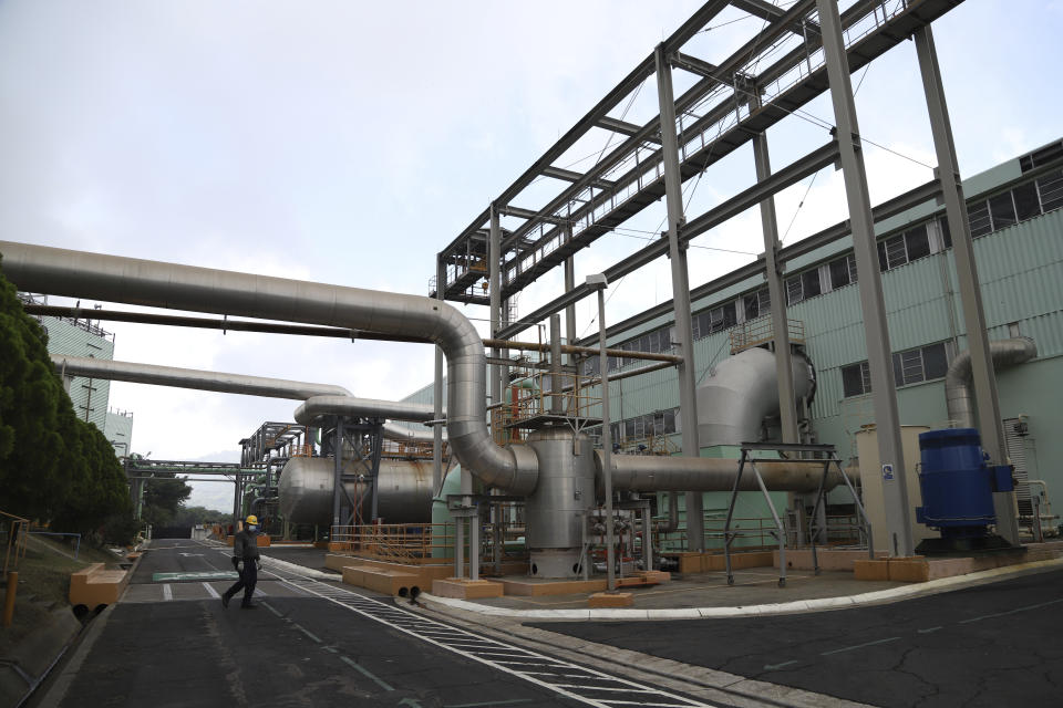 A state employee works amid the cooling systems at La Geo Geothermal Power Plant in Berlin municipality, Usulutan department, El Salvador, Friday, Oct. 15, 2021. The government announced that it has installed 300 processors at this plant to "mine" cryptocurrency, and is using geothermal resources from the country’s volcanos to run the computers that perform the calculations to verify transactions in bitcoin, recently made legal tender. (AP Photo/Salvador Melendez)