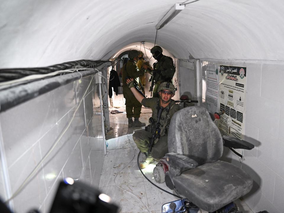 An Israeli soldier gestured in what the military described as a Hamas command tunnel running partly under UNRWA headquarters.