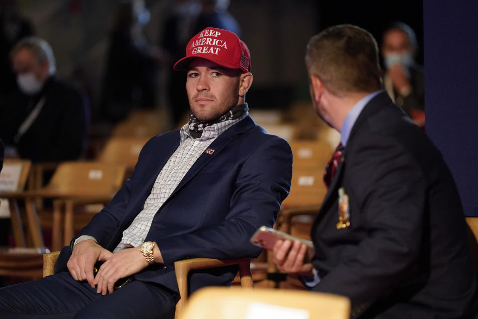 UFC fighter Colby Covington takes his seat as a guest of President Donald Trump to watch the first presidential debate Tuesday, Sept. 29, 2020, at Case Western University and Cleveland Clinic, in Cleveland, Ohio. (AP Photo/Patrick Semansky)