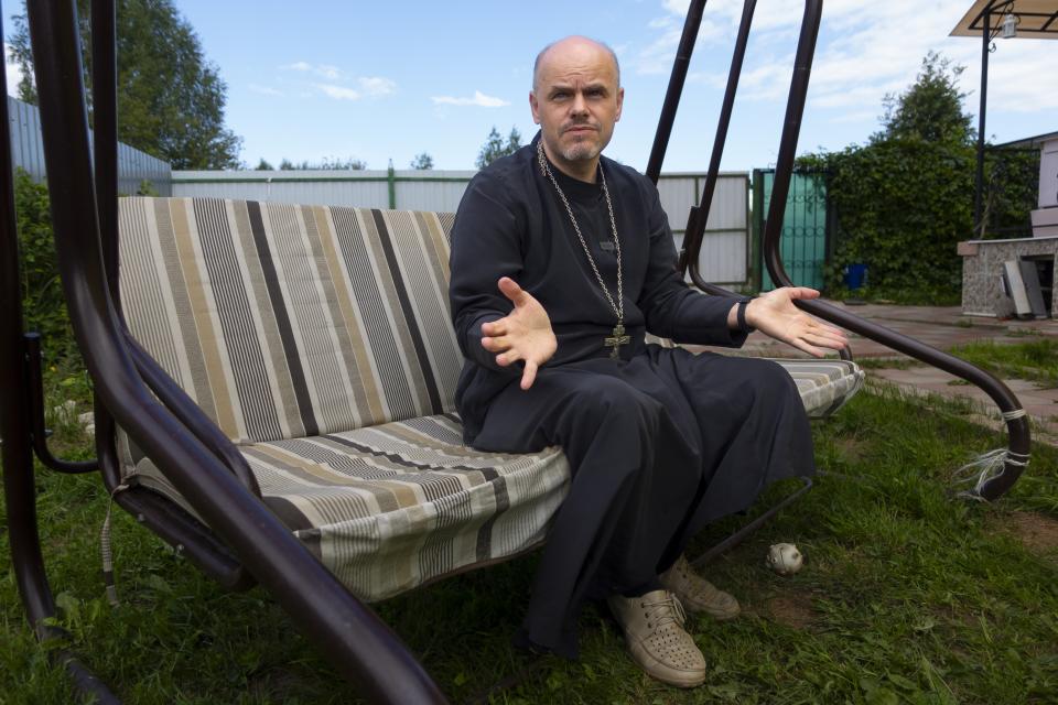 The Rev. Ioann Burdin gestures while speaking at the courtyard of his house in the village of Nikolskoye, Kostroma Region, 91 km (57 miles) north-east of Moscow, Russia, Monday, July 17, 2023. Burdin wanted to leave the Russian Orthodox Church after he spoke out against Russia's decision to send troops into Ukraine at a small church near Kostroma, and the local court fined him for discrediting the Russian army. He asked the patriarch to approve his transfer to the Bulgarian Orthodox Church but instead, Kirill banned him from service until the priest made a public apology. (AP Photo)