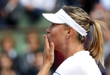 Maria Sharapova of Russia celebrates after beating Kaia Kanepi of Estonia during their women's singles match at the French Open tennis tournament at the Roland Garros stadium in Paris, France, May 25, 2015. REUTERS/Jean-Paul Pelissier