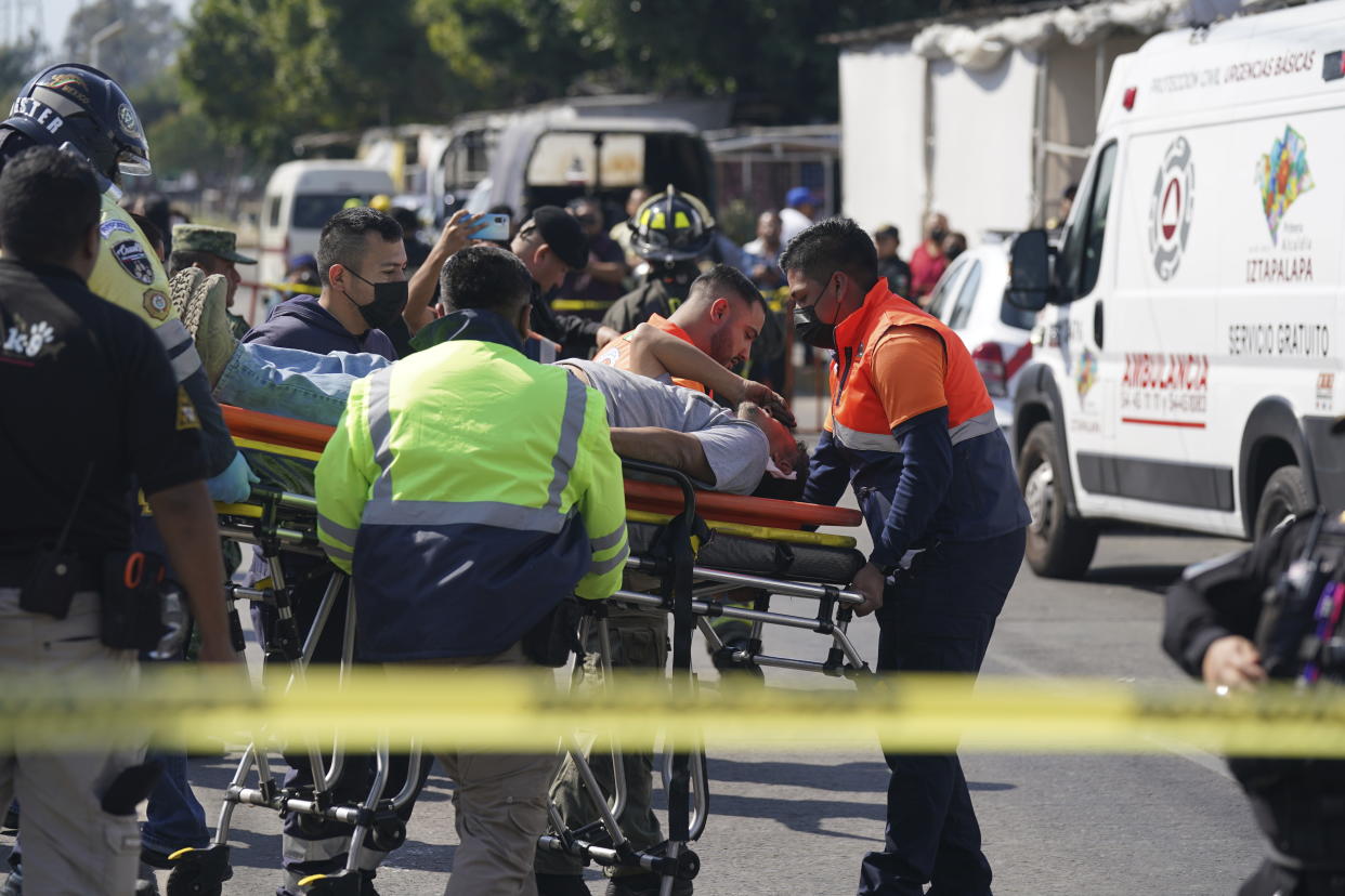 A subway passenger, injured when two subway trains collided, is taken on a stretcher to a waiting ambulance, outside the Raza station in Mexico City, Saturday, Jan. 7, 2023. Authorities announced at least one person was killed and dozens were injured in the Saturday accident on Line 3 of the capital's subway. (AP Photo/Fernando Llano)