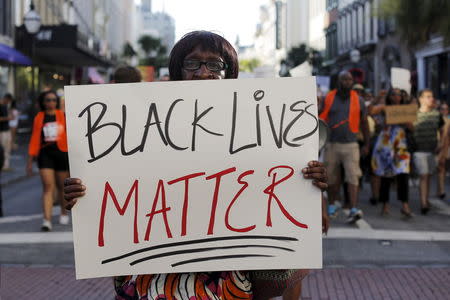 Louise Brown walks in the "March for Black Lives" after passing by the Emanuel African Methodist Episcopal Church in Charleston, South Carolina June 20, 2015 three days after a mass shooting left people nine dead during a bible study at the church. REUTERS/Brian Snyder