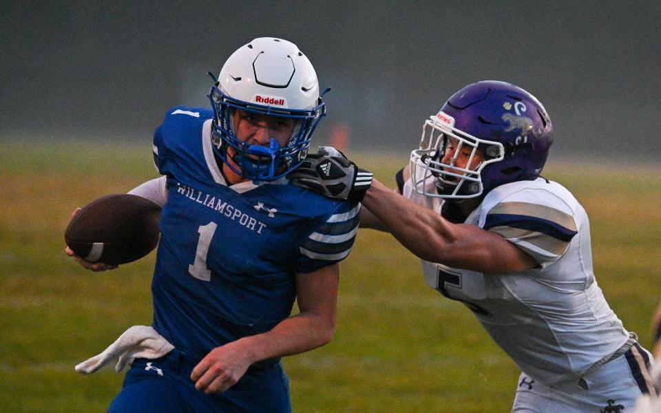 Williamsport quarterback Nolan Raley tries to elude the grasp of Smithsburg's Bruce Reynolds.