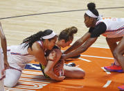 Connecticut Sun center Brionna Jones, left, and forward Kaila Charles wrap-up Dallas Wings guard Marina Mabrey during a WNBA basketball game Tuesday, June 22, 2021 at Mohegan Sun Arena in Uncasville, Conn. (Sean D. Elliot/The Day via AP)