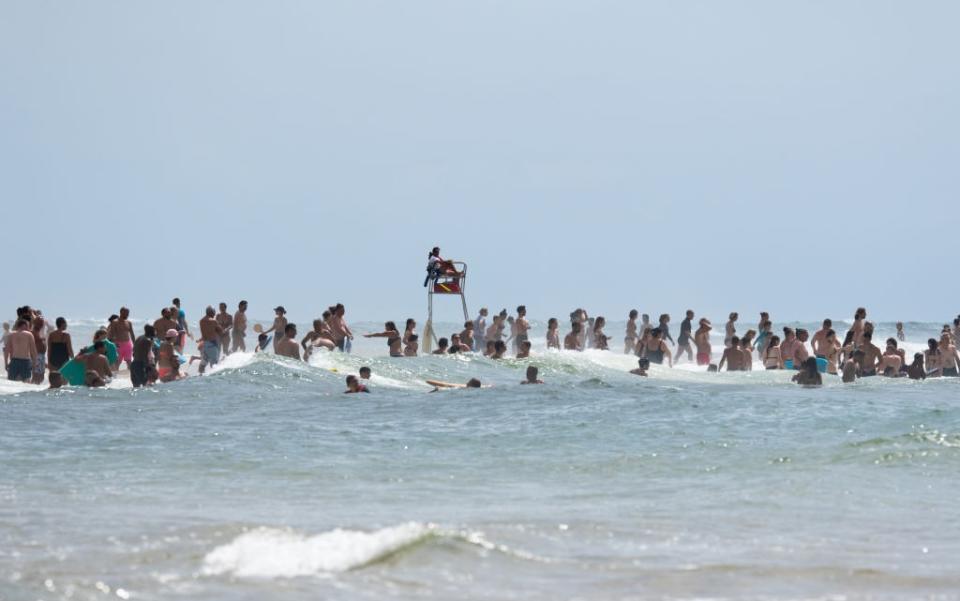 Beachgoers make the most of the good weather in south-west France - getty