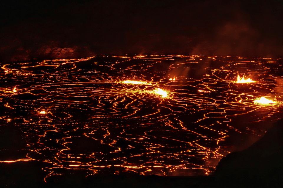 This photo provided by Volcano Hideaways shows lava erupting at Kilauea volcano's summit crater in Hawaii National Park, Hawaii on Friday, Jan. 6, 2023. Hawaii's Kilauea, one of the world's most active volcanoes, is erupting again and providing a spectacle that includes bursting lava fountains and lava "waves" but no Big Island communities are in danger.(Jillian Marohnic/Volcano Hideaways via AP)