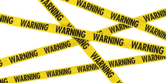 criss-crossed yellow tape, with the word warning repeated along it