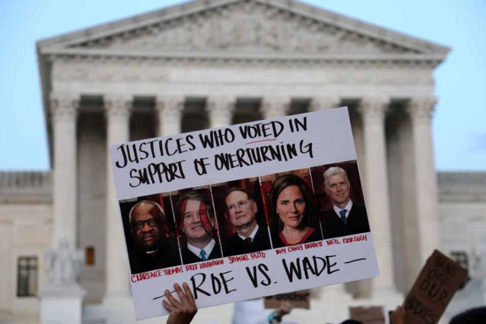 A pro-choice activist holds up a sign during a rally in front of the U.S. Supreme Court in response to the leaked Supreme Court draft decision to overturn Roe v. Wade May 3, 2022 in Washington, DC. (Photo by Alex Wong/Getty Images)