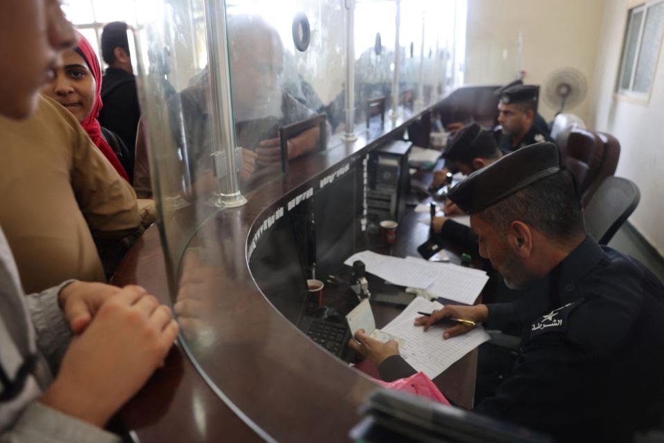 Civilians leaving the Gaza, have their papers checked as dual national Palestinians and foreigners prepare to cross the southern Rafah border point with Egypt, in the southern Gaza Strip, on November 3, 2023. (Photo by Mohammed ABED / AFP) (Photo by MOHAMMED ABED/AFP via Getty Images)