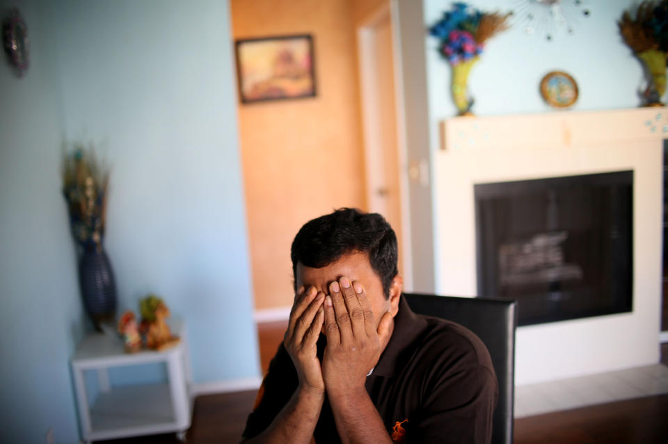 Raj, an immigrant from Sri Lanka, sits in his apartment in San Diego, California, U.S., April 9, 2017. Picture taken April 9, 2017. REUTERS/Sandy Huffaker