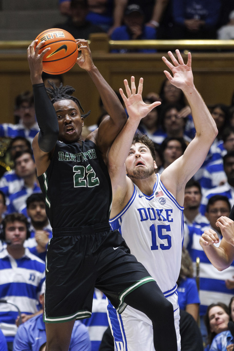 Dartmouth's Jayden Williams (22) and Duke's Ryan Young (15) battle for a rebound during the first half of an NCAA college basketball game in Durham, N.C., Monday, Nov. 6, 2023. (AP Photo/Ben McKeown)