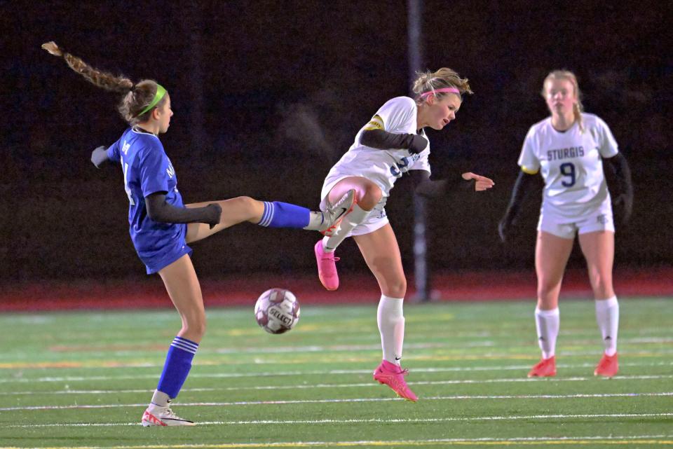 Izzadora Almeida of Mashpee kicks the ball into Abby Jarvis of Sturgis East girls soccer.