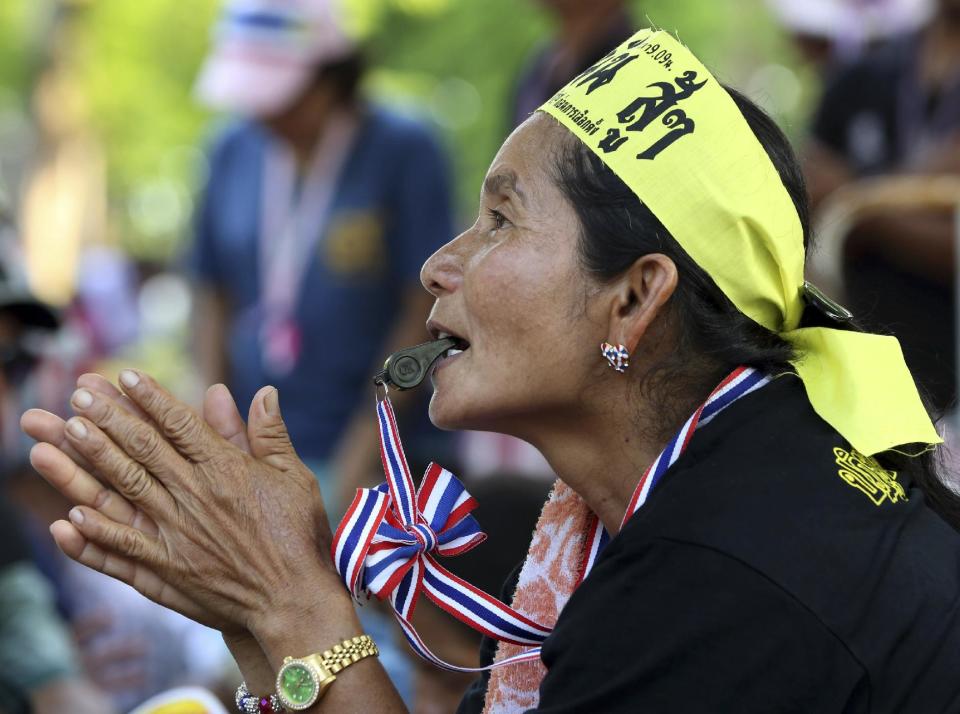 An anti-government protester listens to the speech during a rally outside the parliament in Bangkok, Thailand Monday, May 12, 2014. Emboldened by the removal of Thailand's prime minister, anti-government protesters withdrew from the city's main park Monday and marched to the vacated prime minister's office compound - where the protest leader has pledged to set up his new office. (AP Photo/Apichart Weerawong)