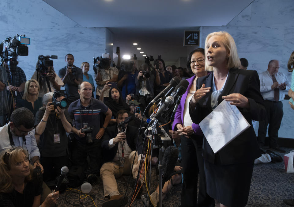 Sen. Kirsten Gillibrand, D-N.Y., joined at rear by Sen. Mazie Hirono, D-Hawaii, holds a letter of support from alumnae from the Holton-Arms School, the Maryland all-girls school that Christine Blasey Ford attended in the early 1980s, who is accusing Supreme Court nominee Brett Kavanaugh of a decades-old sexual attack, during a news conference on Capitol Hill in Washington, Thursday, Sept. 20, 2018. (AP Photo/J. Scott Applewhite)