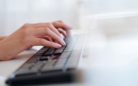 Businesswoman typing on keyboard - Credit: JGI/Jamie Grill