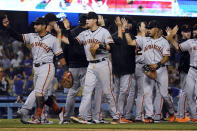 The San Francisco Giants celebrates a win over the Los Angeles Dodgers in a baseball game Wednesday, July 21, 2021, in Los Angeles. (AP Photo/Marcio Jose Sanchez)
