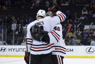 Chicago Blackhawks defenseman Seth Jones (4) and goaltender Arvid Soderblom (40) embrace after defeating the New York Rangers in an NHL hockey game, Saturday, Dec. 3, 2022, in New York. (AP Photo/Jessie Alcheh)