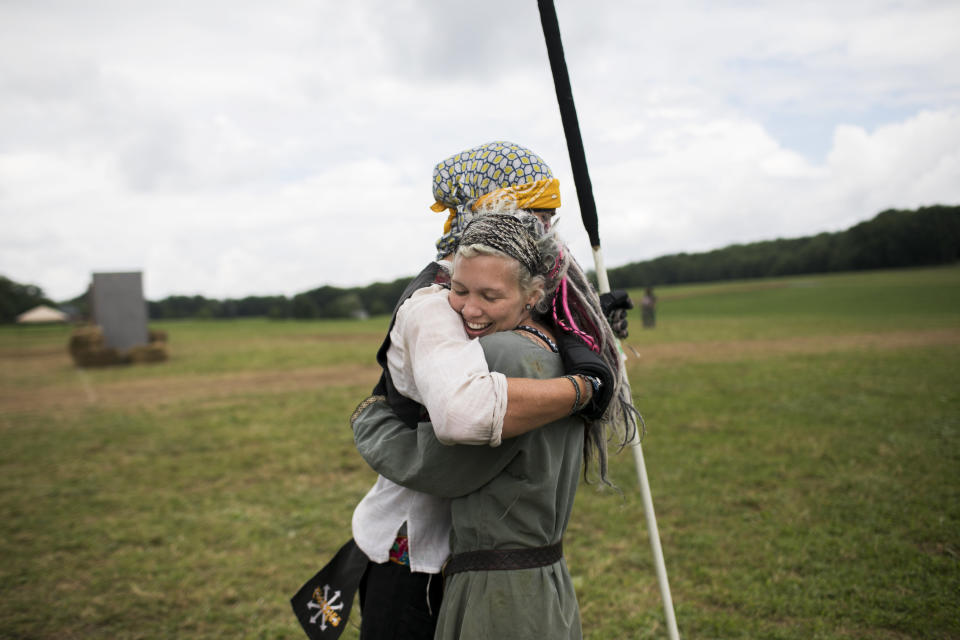 Attendees hug on the field while training for battle.&nbsp; (Photo: Maddie McGarvey for HuffPost)