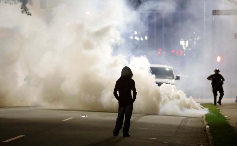 A protester faces clouds of tear gas during nationwide unrest following the death in Minneapolis police custody of George Floyd, in Raleigh