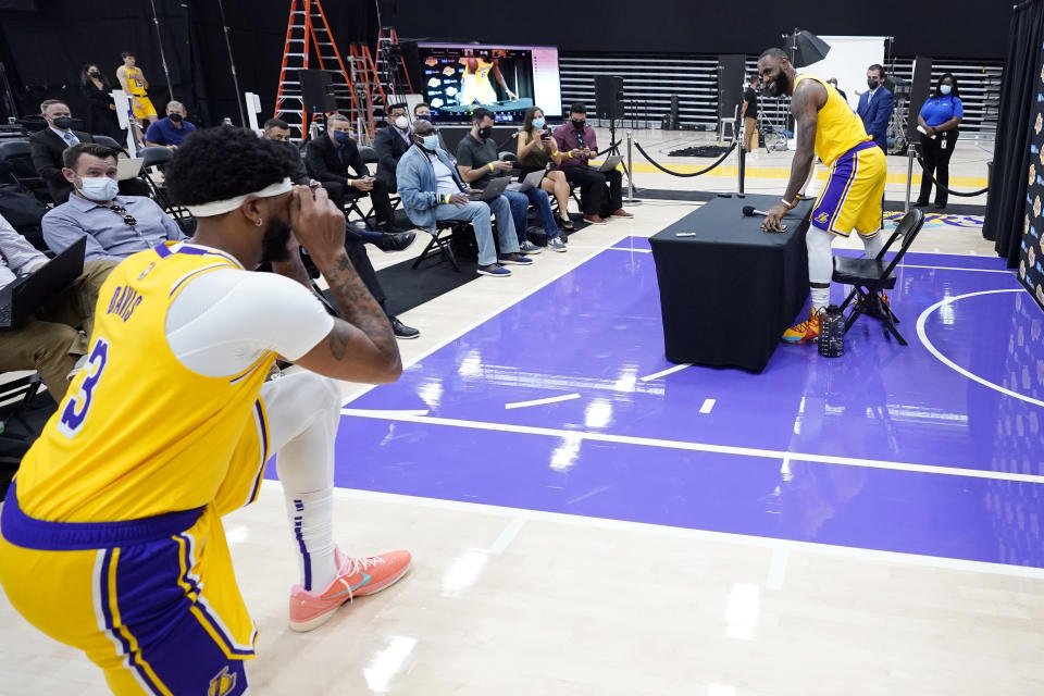 Los Angeles Lakers forward LeBron James, right, has his photo taken by teammate Anthony Davis during the NBA basketball team's Media Day Tuesday, Sept. 28, 2021, in El Segundo, Calif. (AP Photo/Marcio Jose Sanchez)