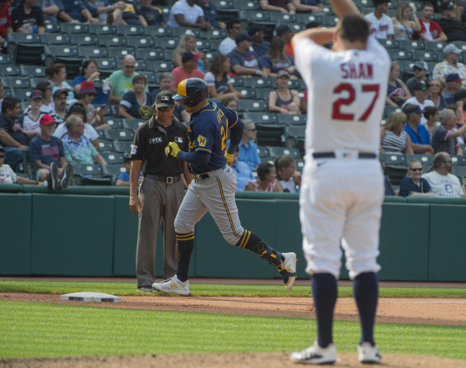 Milwaukee Brewers' Avisail Garcia, center, rounds the bases after hitting a three-run home run off Cleveland Indians relief pitcher Bryan Shaw, right, during the eighth inning of a baseball game in Cleveland, Sunday, Sept. 12, 2021. (AP Photo/Phil Long)