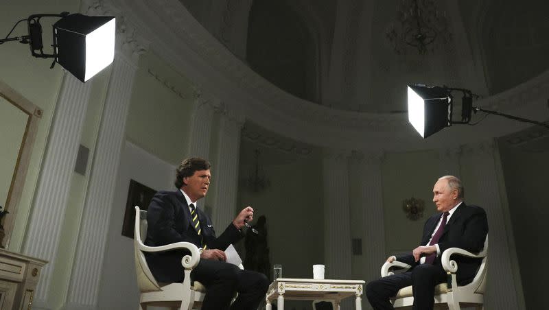 In this photo released by Sputnik news agency on Friday, Feb. 9, 2024, Russian President Vladimir Putin, right, listens to a question during an interview with former Fox News host Tucker Carlson at the Kremlin in Moscow, Russia, Tuesday, Feb. 6, 2024.