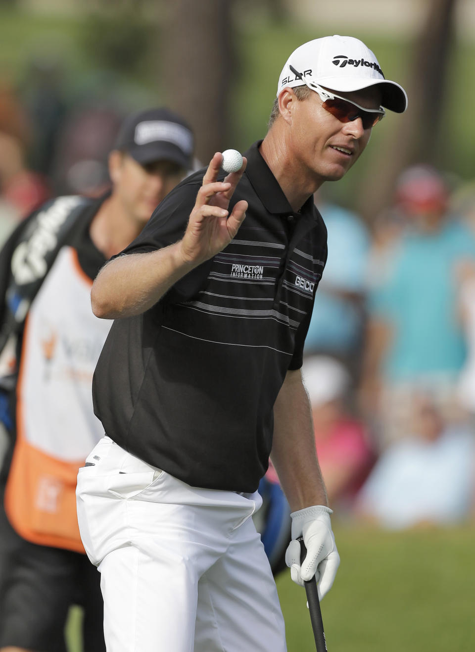 John Senden, of Australia, holds up his ball after chipping in for birdie on the 16th hole during the final round of the Valspar Championship golf tournament at Innisbrook Sunday, March 16, 2014, in Palm Harbor, Fla. Senden went onto win the tournament. (AP Photo/Chris O'Meara)