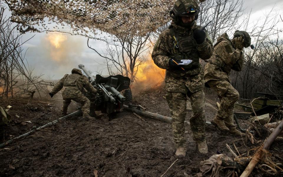 Ukrainian soldiers fire a D-44 artillery piece toward Russian positions in Bakhmut