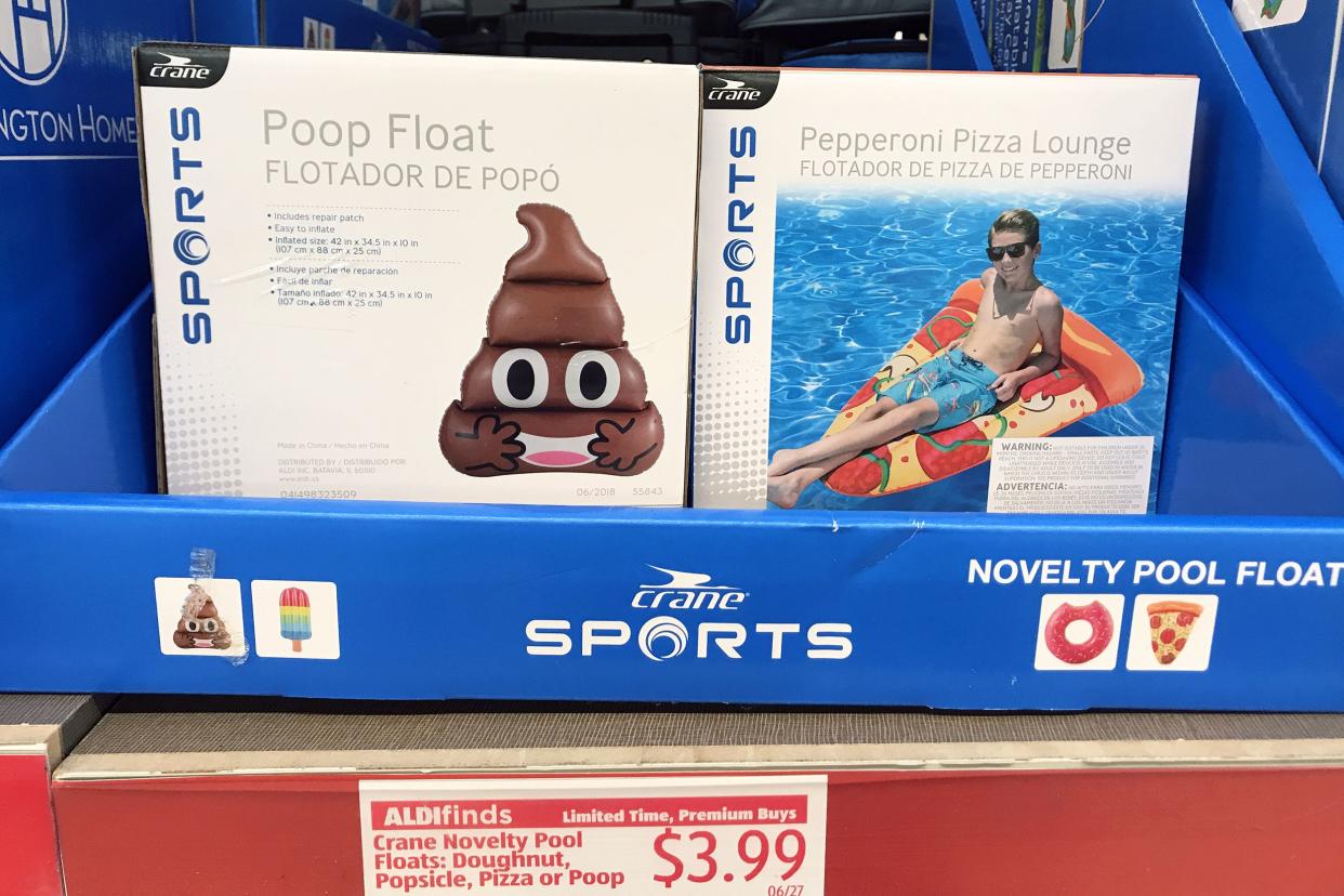 Closeup of a poop emoji float and a pepperoni pizza lounge float at an Aldi store with price sticker underneath of '$3.99' with description, in a blue cardboard holder