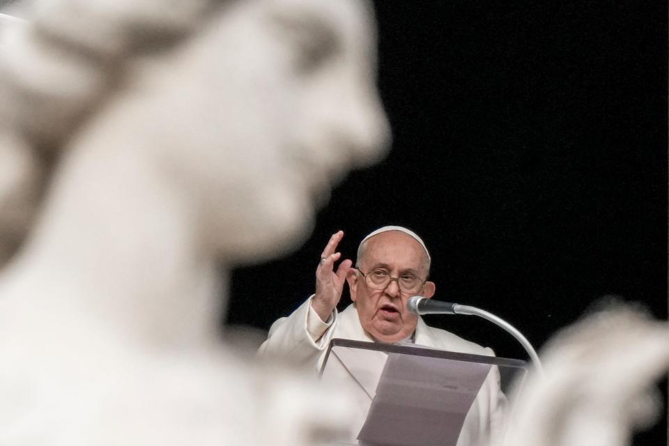 Pope Francis delivers his blessing as he recites the Angelus noon prayer from the window of his studio overlooking St. Peter's Square at the Vatican on Friday, Dec. 8, 2023.