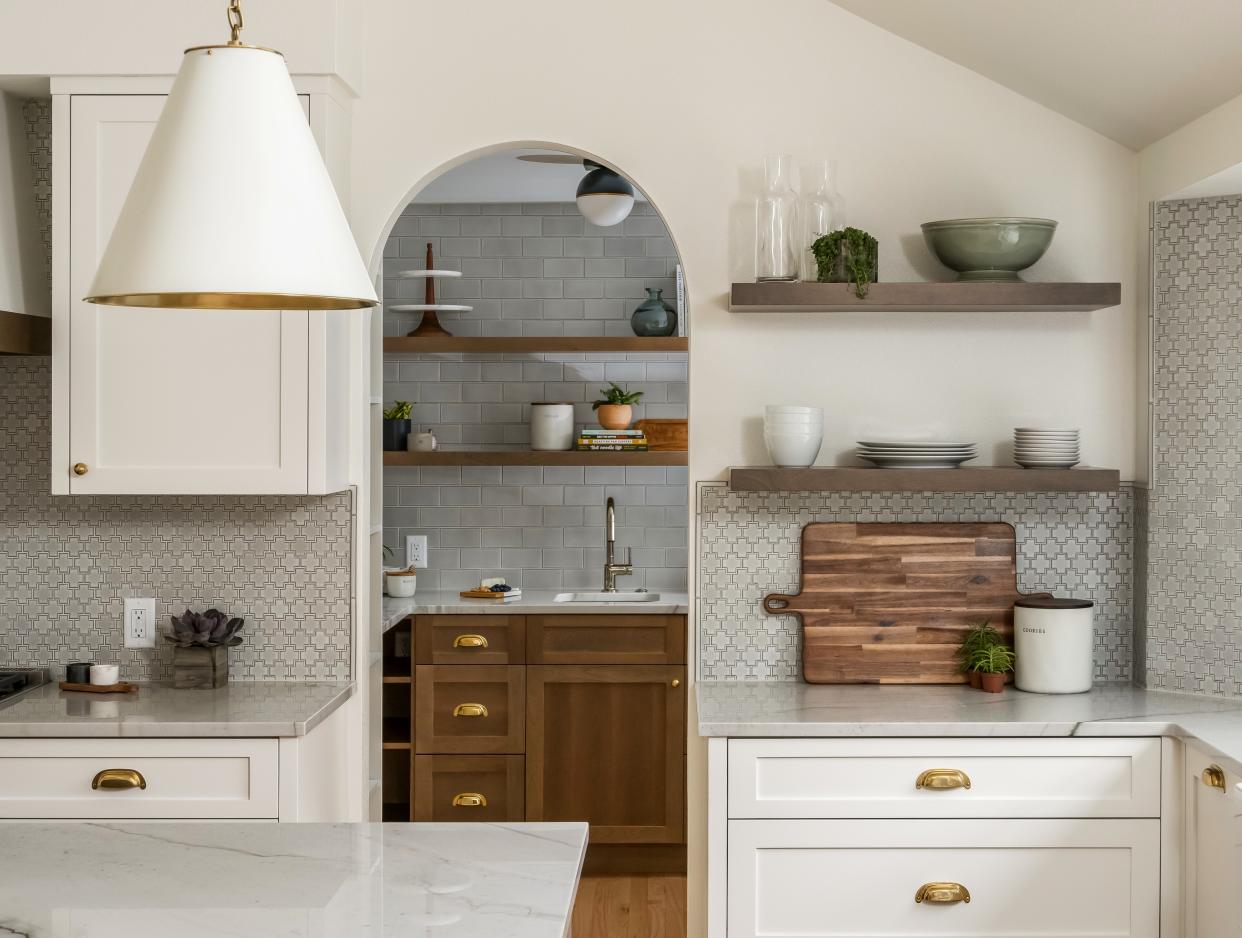  A kitchen with a butlers pantry located behind. 