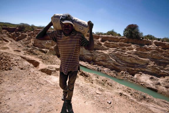 A man carries a bag of copper at a mine quarry and cobalt pit in Lubumbashi on May 23, 2016.