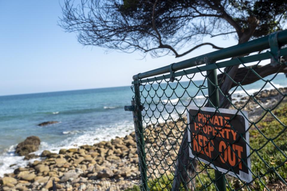 A "private property, keep out" sign attached to a gate