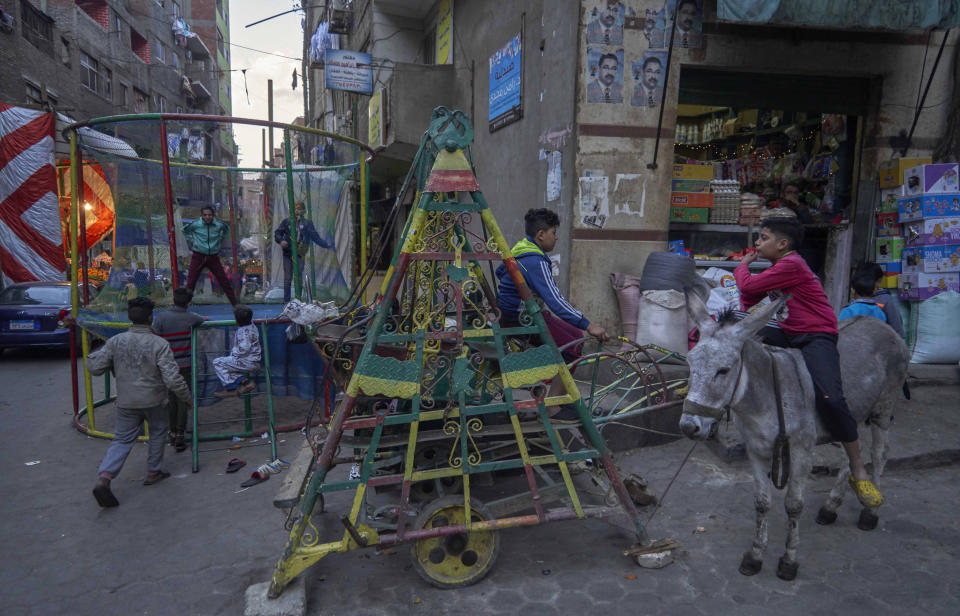 Coptic children play in a makeshift playground during their vacation for Coptic Christmas, at a residential and industrial area of eastern Cairo, Egypt, Monday, Jan. 6, 2020. (AP Photo/Hamada Elrasam)